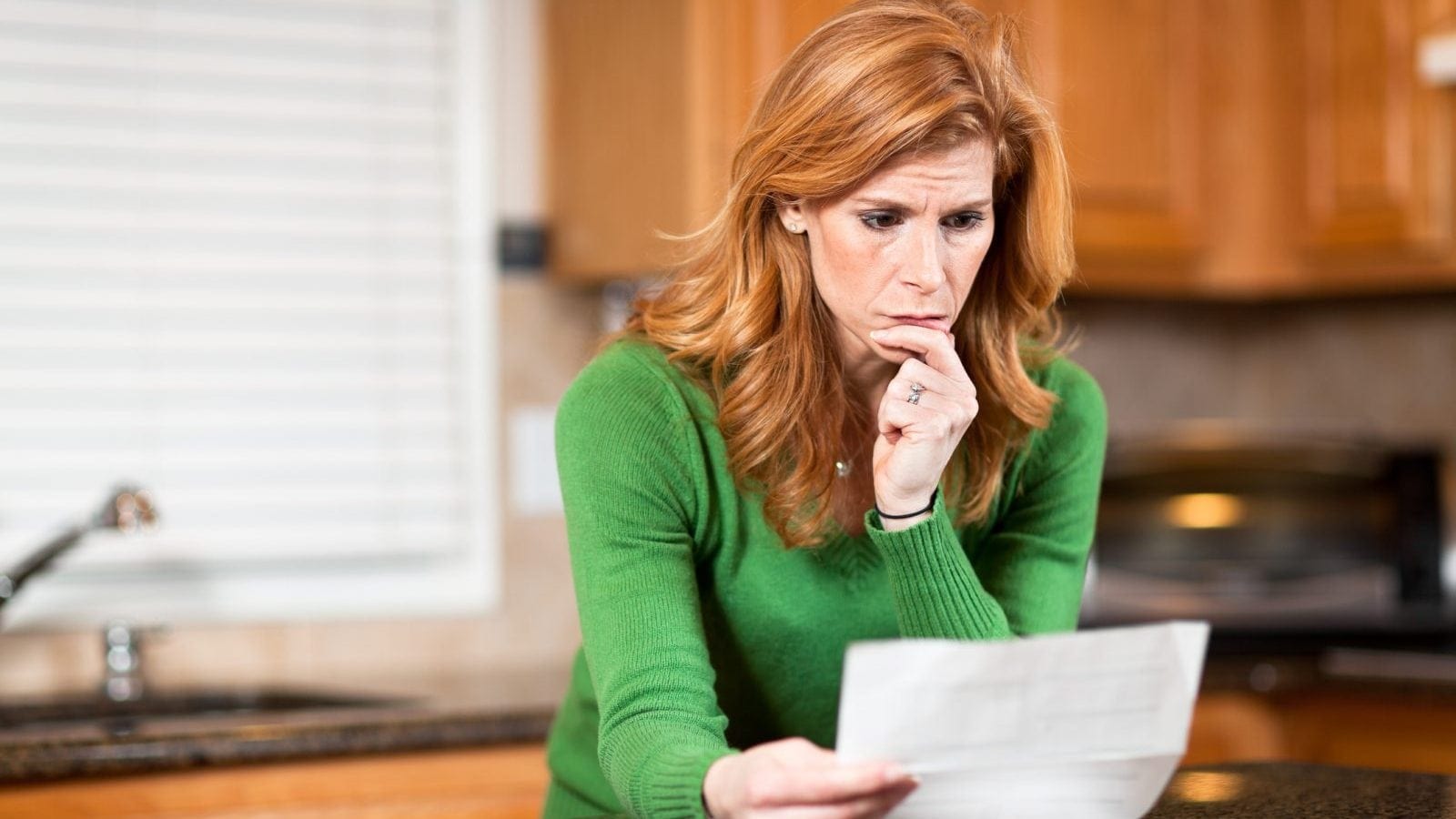 Woman Reading Denial Letter Stock Photo